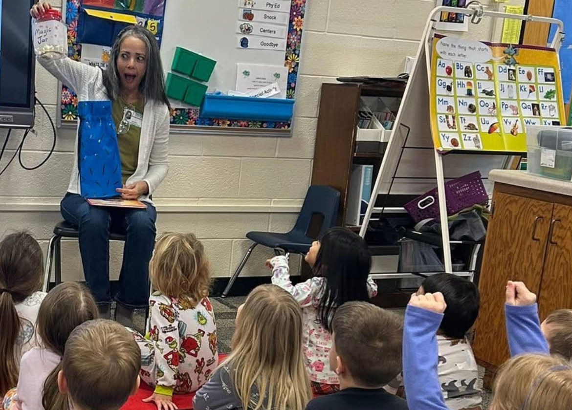 Author school visit with students gathered for story time